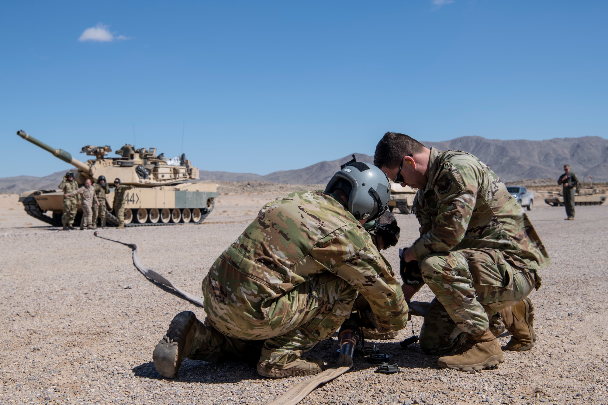 U.S. Air Force Airmen from the 40th Airlift Squadron and 7th Logistics Readiness Squadron ready a fuel hose during Operation Night King in the California desert March 26, 2023.