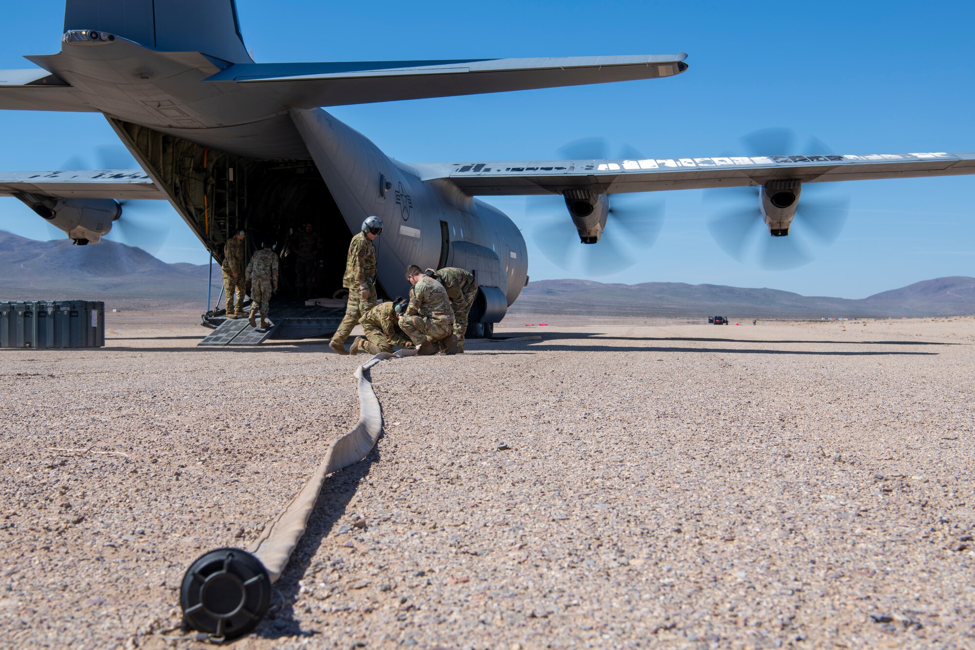 U.S. Air Force Airmen from the 317th Airlift Wing prepare a fuel hose during Operation Night King in the California desert March 26, 2023.