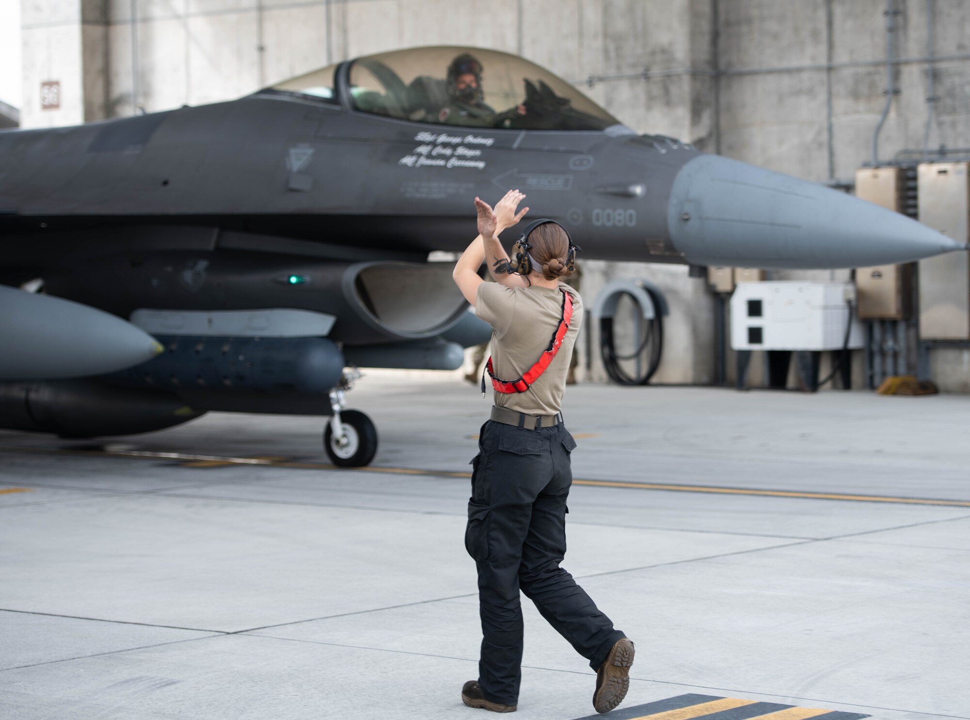 An Airman marshals an aircraft.