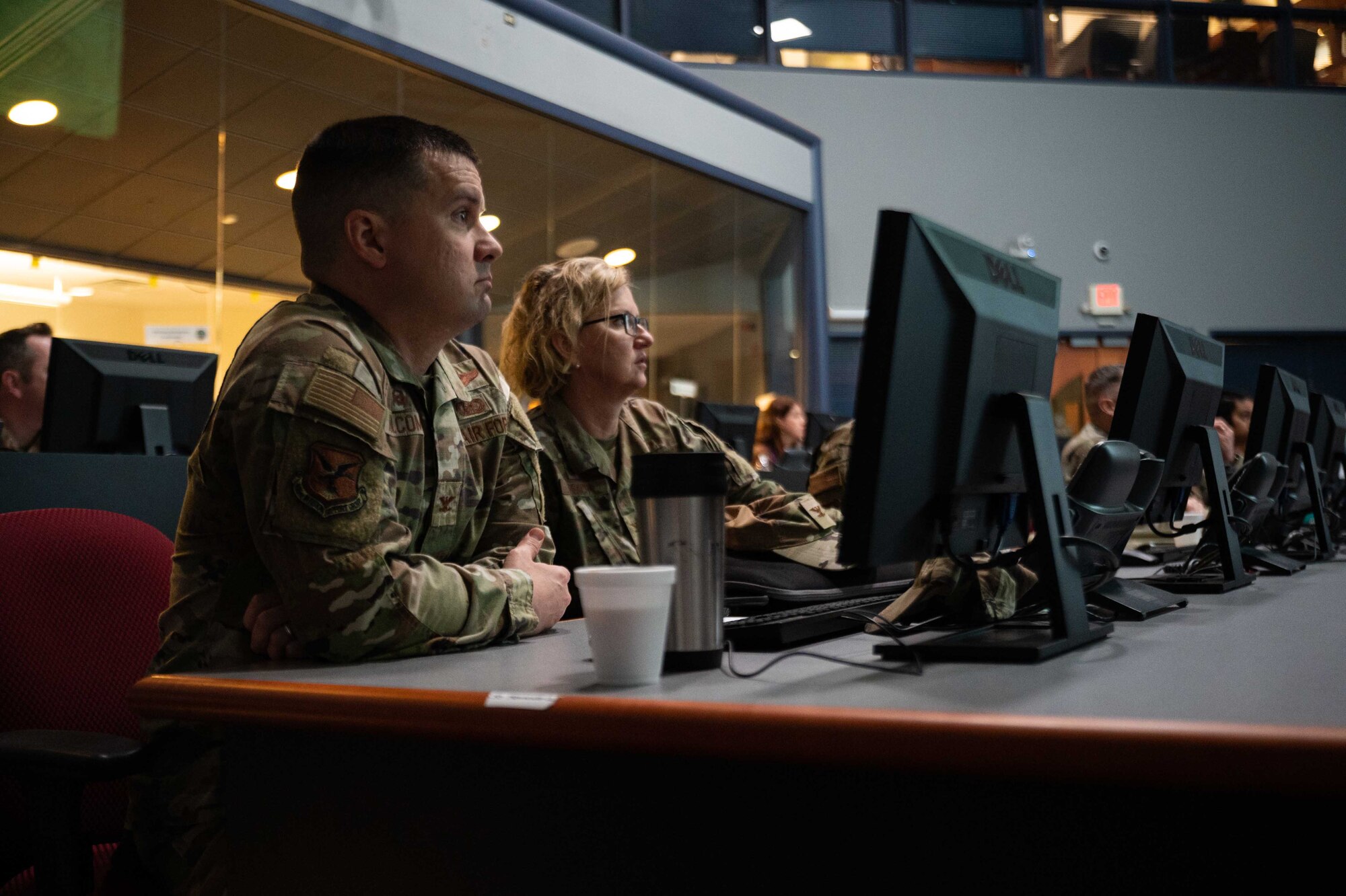From the left, Col. Jason Holcomb, 436th Mission Support Group commander, and Col. Crystal Beach, 512th MSG commander, listen to a briefing at a Delaware Emergency Management Agency immersion event in Smyrna, Delaware, April 6, 2023. During the event, DEMA was able to share best practices with Team Dover Airmen regarding preparedness for natural disasters, terrorism response, emergency operations center training, behavior threat analysis for school safety and community engagement. (U.S. Air Force photo by Senior Airman Faith Barron)