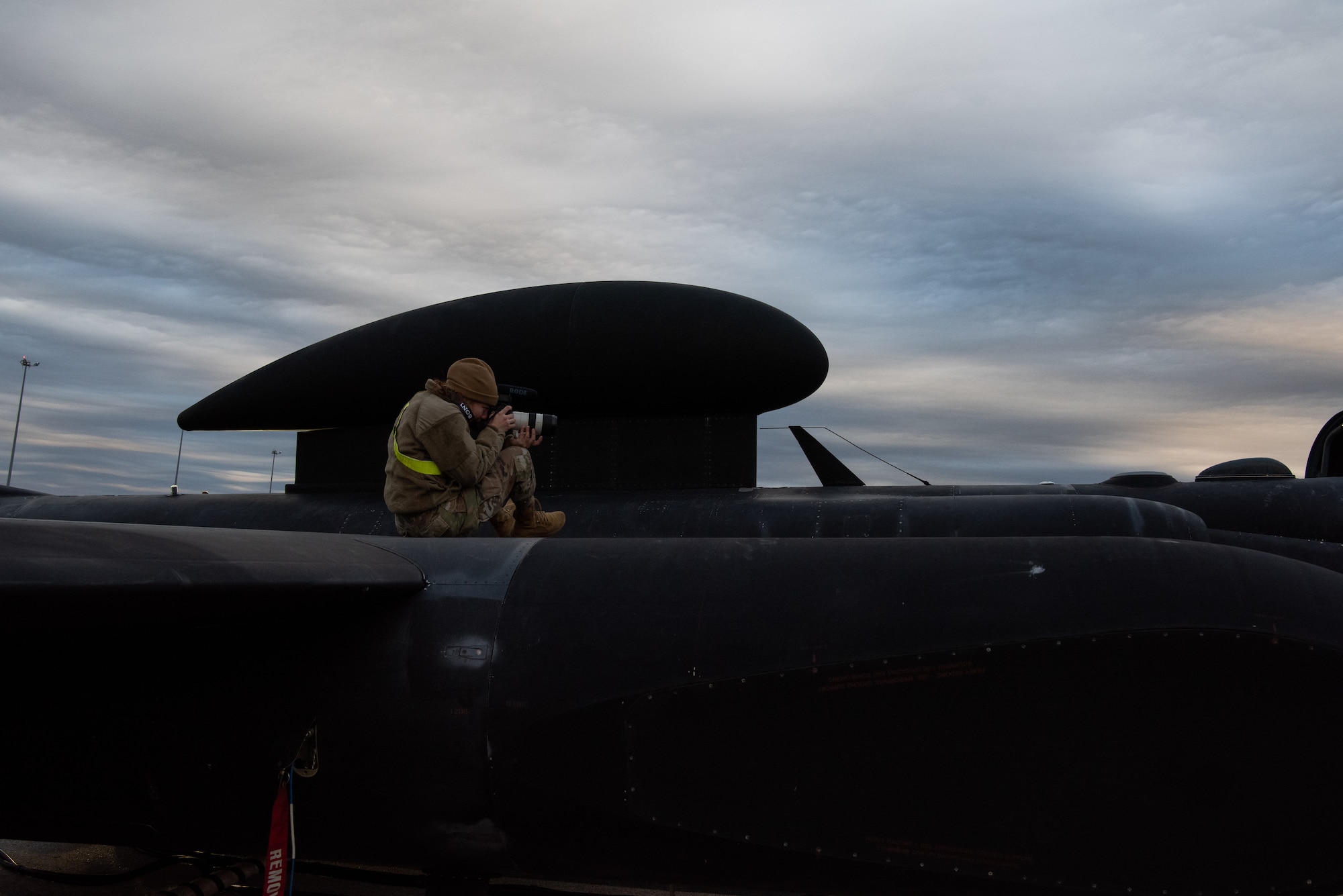 A U.S. Air Force 9th Reconnaissance Wing Public Affairs photojournalist documents the preparation of the U-2 Dragon Lady before a high altitude sortie during Dragon Flag EAST, April 3, 2023, at Offutt Air Force Base, Nebraska.
