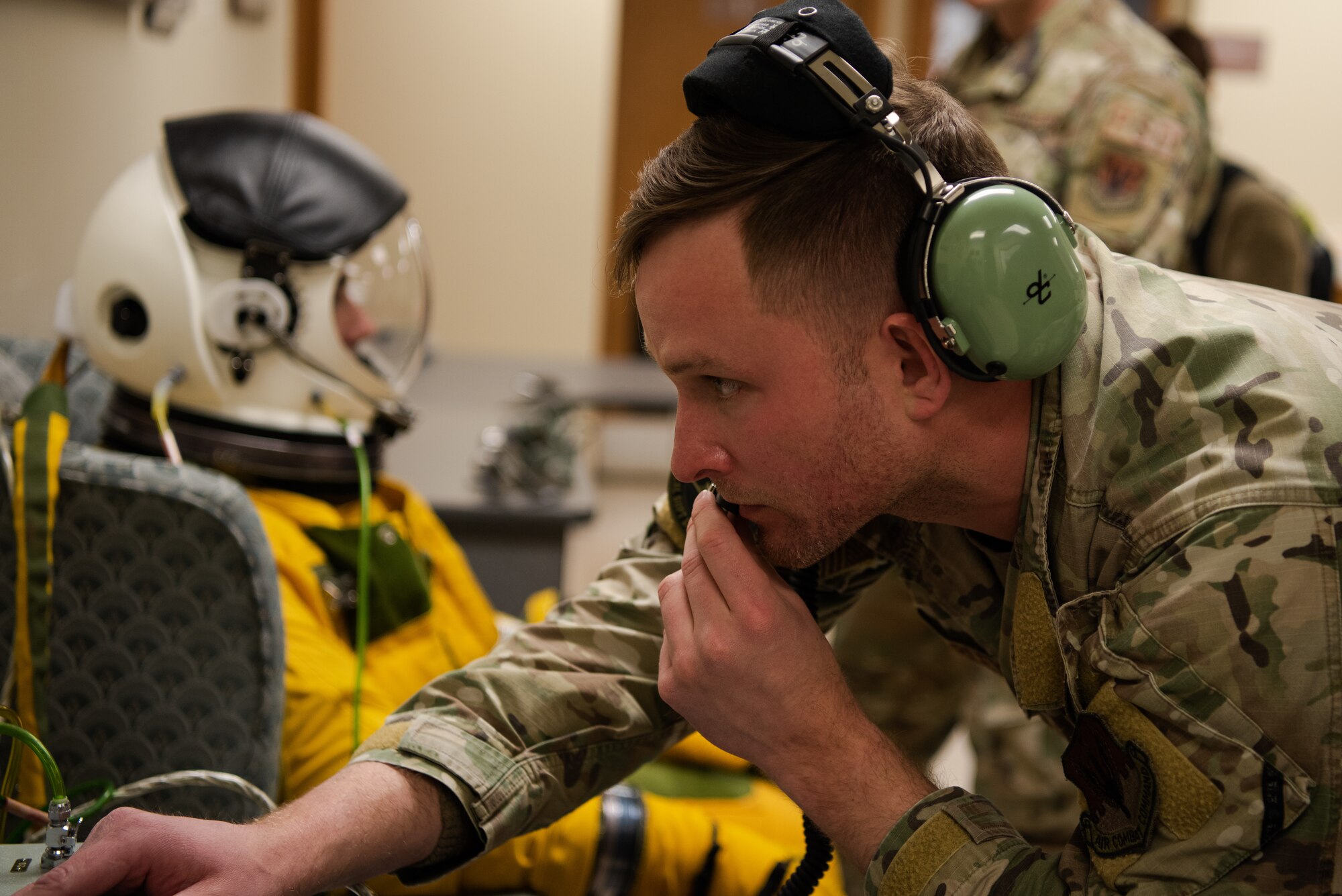 A U.S. Air Force 9th Physiological Support Squadron launch and recovery section NCO in charge speaks to a 99th Reconnaissance Squadron U-2 Dragon Lady pilot as their suit pressurizes for a high flight April 1, 2023, at Offutt Air Force Base, Nebraska.