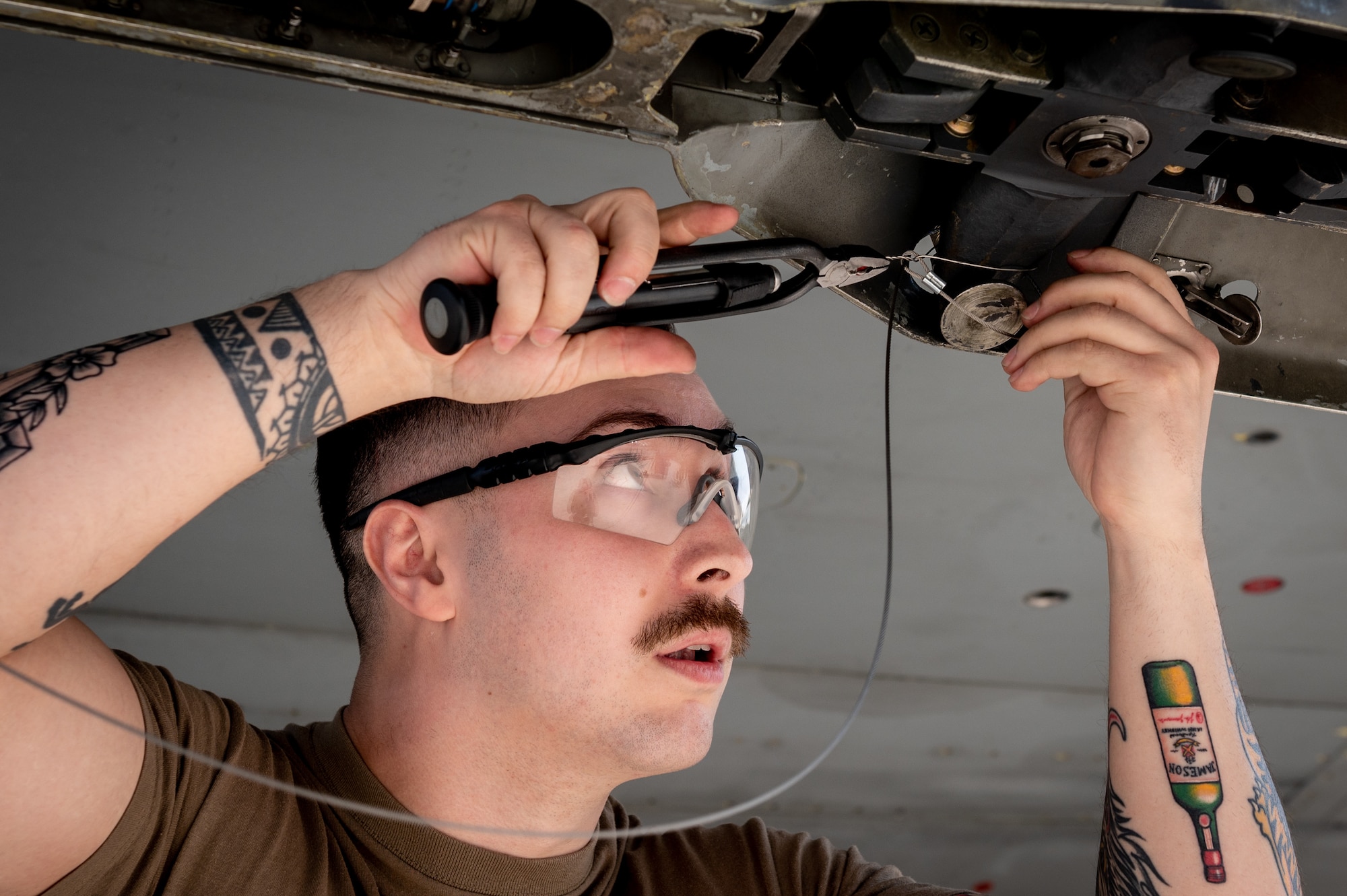 U.S. Air Force Senior Airman Jac Bobadilla, 36th Fighter Generation Squadron weapons load crew member, loads a practice wire guided bomb on a F-16 Fighting Falcon during a weapons load crew of the quarter competition at Osan Air Base, Republic of Korea, Mar. 31, 2023.