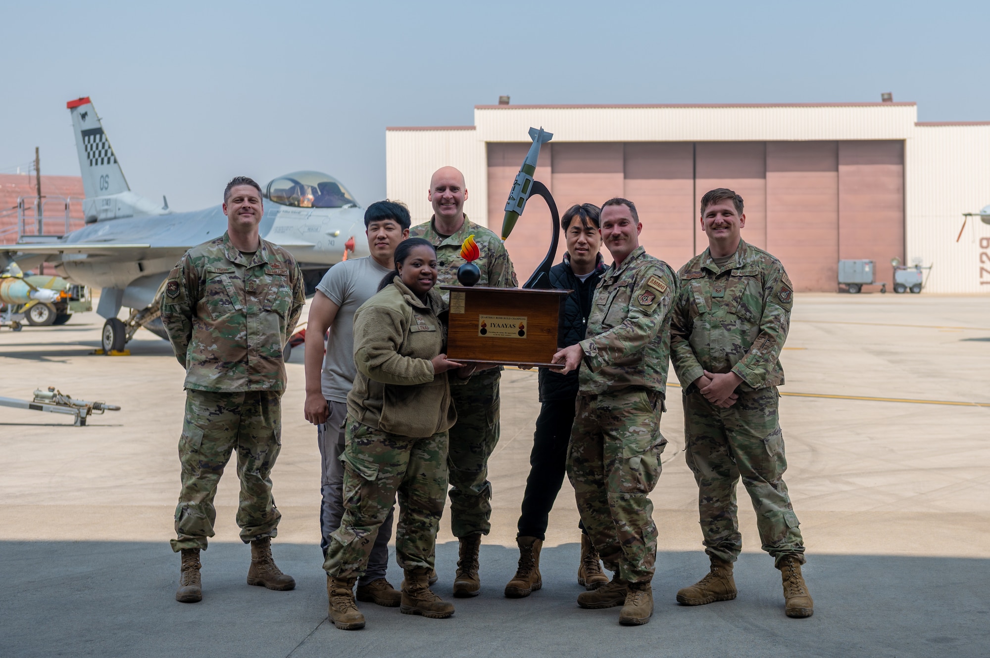 The 36th Fighter Generation Squadron competitors pose with their trophy from the weapons load crew of the quarter competition at Osan Air Base, Republic of Korea, on Mar. 31, 2023.