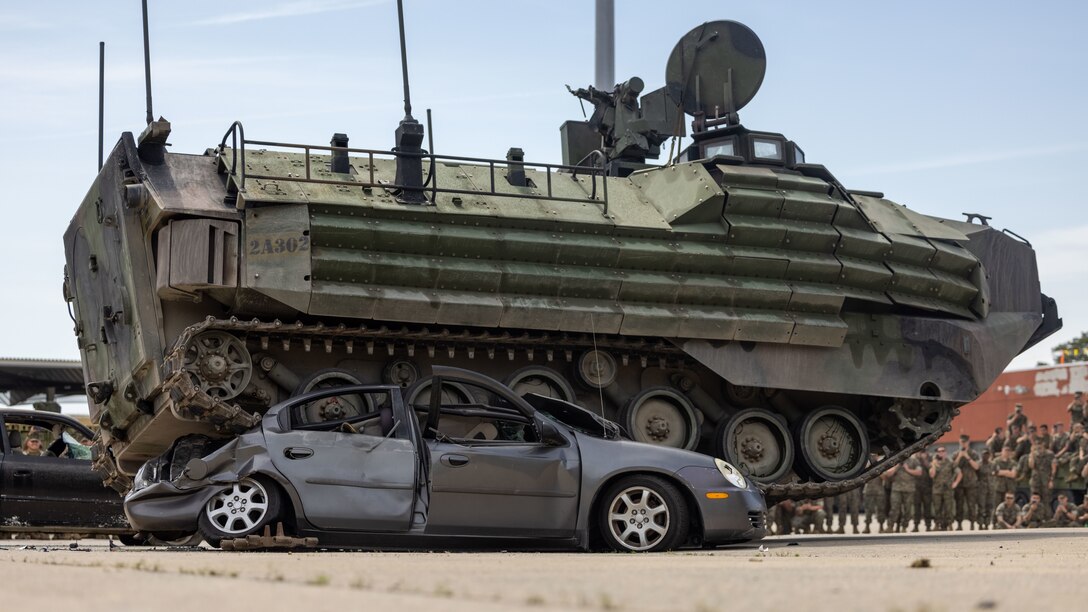 A U.S. Marine Corps AAV7A1 tracked vehicle with 2d Assault Amphibian Battalion (AABn), 2d Marine Division crushes a car during Gator Week on Camp Lejeune, North Carolina, April 6, 2023. Gator Week is an annual field meet with physical team building events that increase unit cohesion and commemorates 2d AABn’s history. (U.S. Marine Corps photo by Lance Cpl. Ryan Ramsammy)