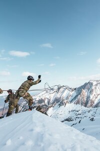 The U.S. Edelweiss Raid team conducts rappel training on the Kitzsteinhorn glacier before the 2023 Edelweiss Raid Feb. 24, 2023, in Austria. Teams must be proficient at creating snow anchors out of skis for the rappelling and crevasse rescue portions of the Raid.