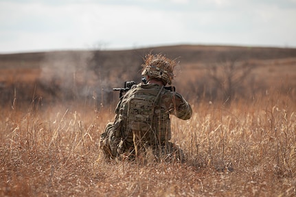 An Oklahoma Army National Guard Soldier with Bravo Company, 1st Battalion, 179th Infantry Regiment, 45th Infantry Brigade Combat Team, fires his M4 during a live fire squad training exercise at Fort Riley, Kan., March 25, 2023. 45th IBCT Soldiers conducted pre-mobilization training in preparation for their upcoming deployment as Task Force Tomahawk supporting operations across multiple East African countries. (Oklahoma National Guard photo by Spc. Tyler Brahic)