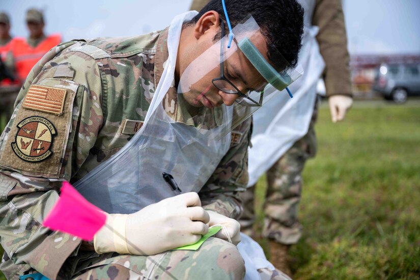 An airman labels a tag.