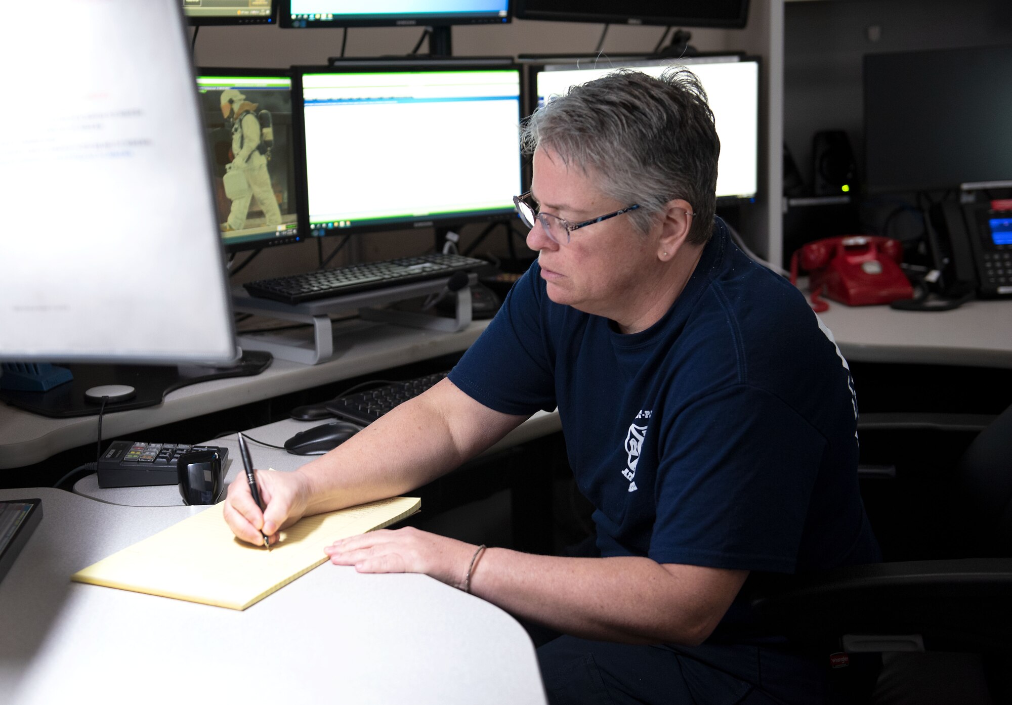 A WPAFB dispatcher takes notes during an emergency call.