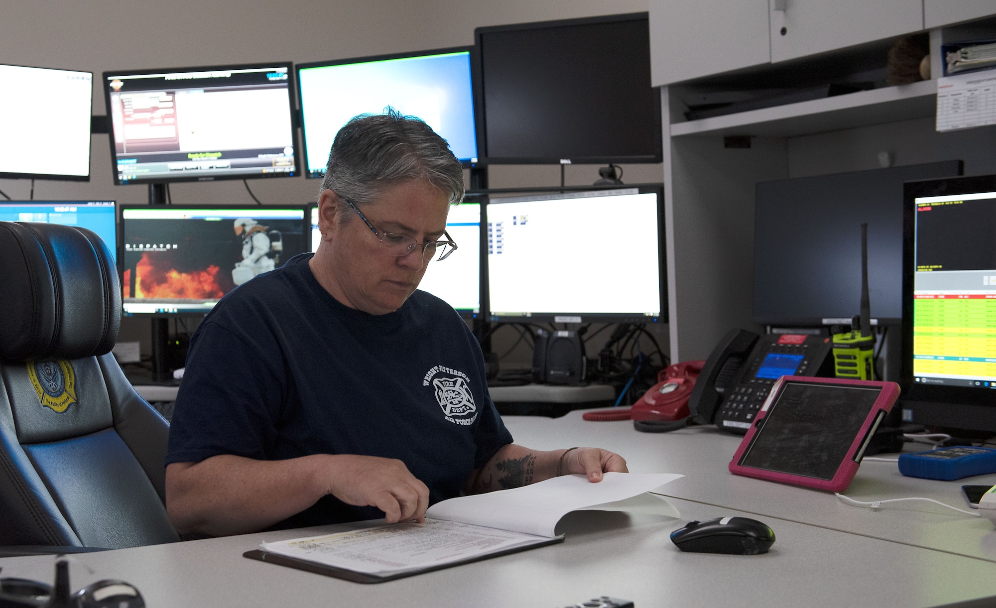 A WPAFB dispatcher checks the daily call log.