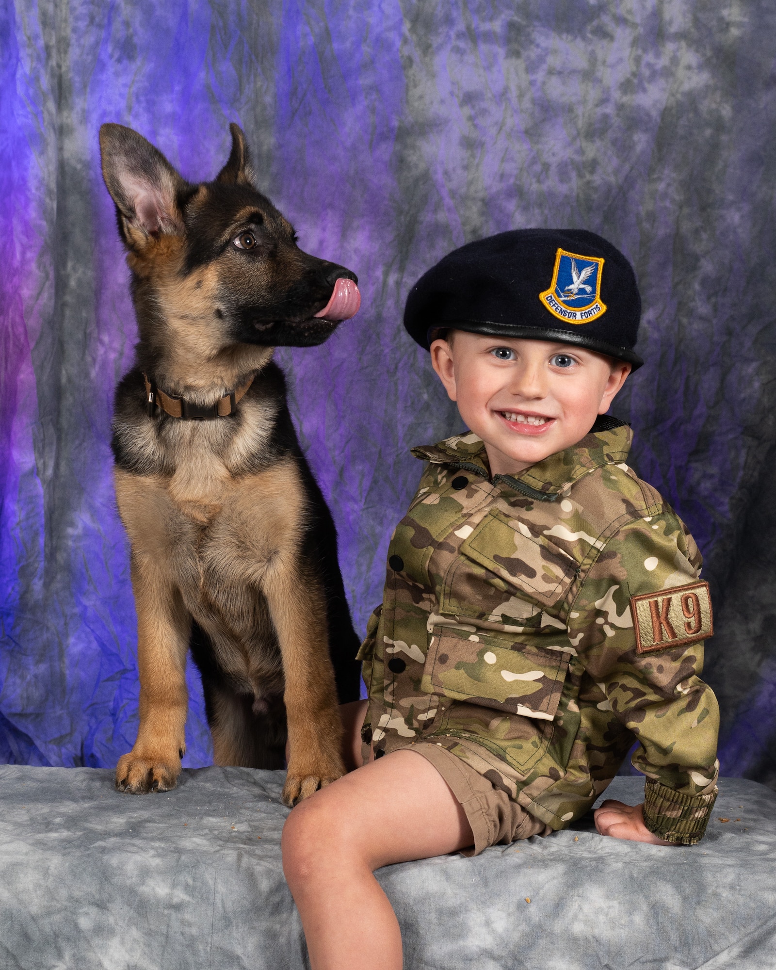 Ellis Dickson, son of Staff Sgt. Jacob Dickson, 436th Security Forces Squadron military working dog handler, poses with Boots at Dover Air Force Base, Delaware, April 11, 2023. Each year, the Department of Defense  joins national, state and local government, schools, military-serving organizations, companies and private citizens in celebrating the estimated 1.6 million military children who face many challenges and unique experiences as a result of their parents' service. (U.S. Air Force photo by Mauricio Campino)