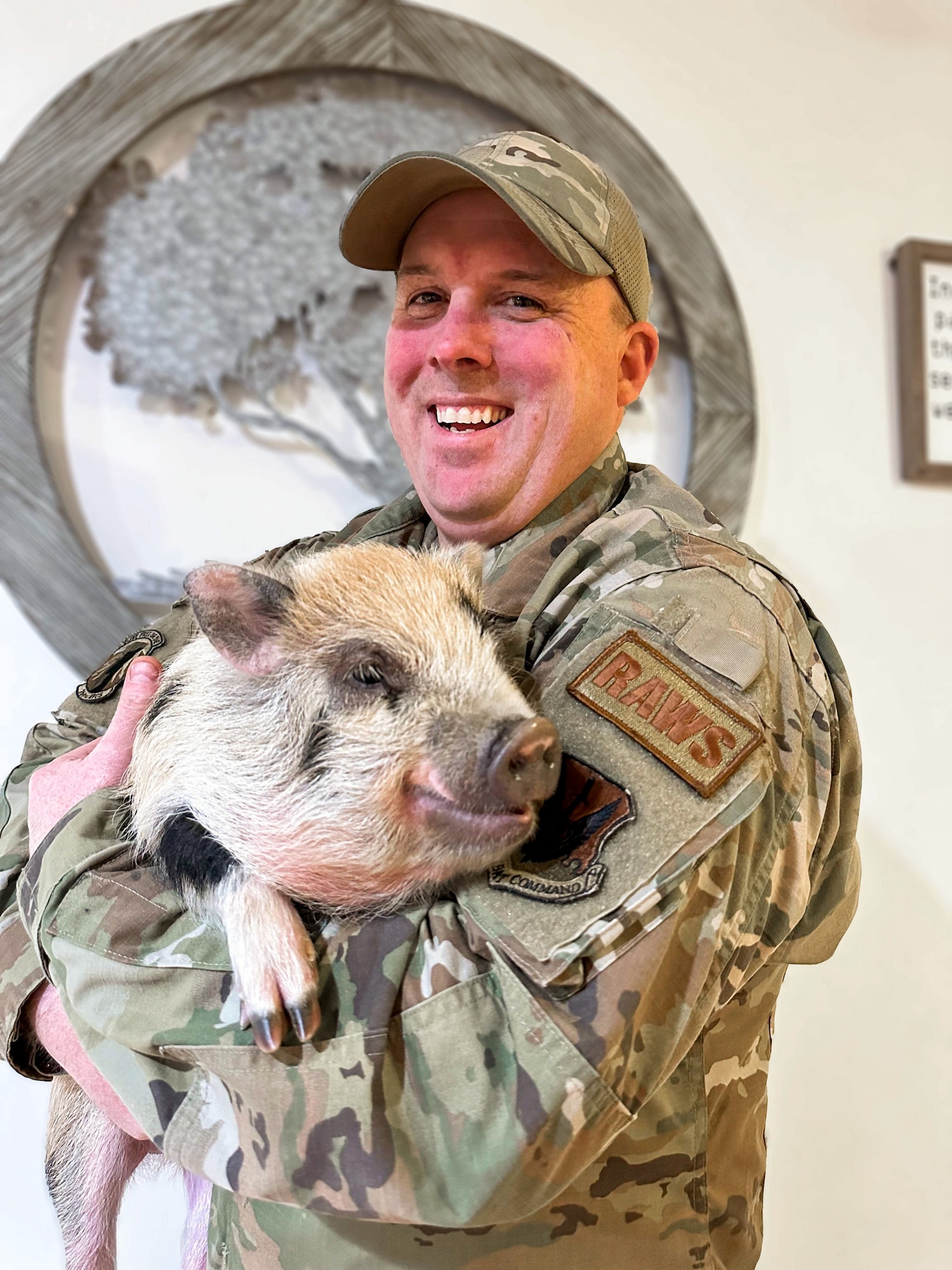 Tech. Sgt. Shawn Sullivan holds Simon the pig