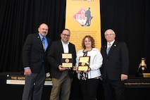 Alan Reynolds (left), NPMA Vice President of Operations, and Ron Crowl (right), NPMA Senior Vice President, present the Program Manager of the Year award to Jesus Ramirez, Huntsvile Center Fuels program manager, and Tracy Helmick, Fuels deputy program manager, during the National Petroleum Management Association's annual conference March 27-30. (Courtesy Photo)