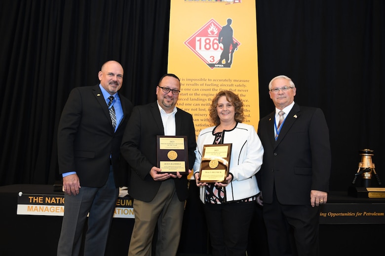 Alan Reynolds (left), NPMA Vice President of Operations, and Ron Crowl (right), NPMA Senior Vice President, present the Program Manager of the Year award to Jesus Ramirez, Huntsvile Center Fuels program manager, and Tracy Helmick, Fuels deputy program manager, during the National Petroleum Management Association's annual conference March 27-30. (Courtesy Photo)