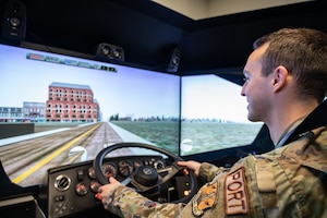 U.S Air Force Staff Sgt. Corey Beecher, assigned to the 103rd Logistics Readiness Squadron, is shown using a driving simulator, April 4, 2023 at Bradley Air National Guard Base, Connecticut. The driving simulator is used to practice driving skills through various scenarios and military vehicles. (U.S. Air National Guard photo by Airman Emme Drummond)