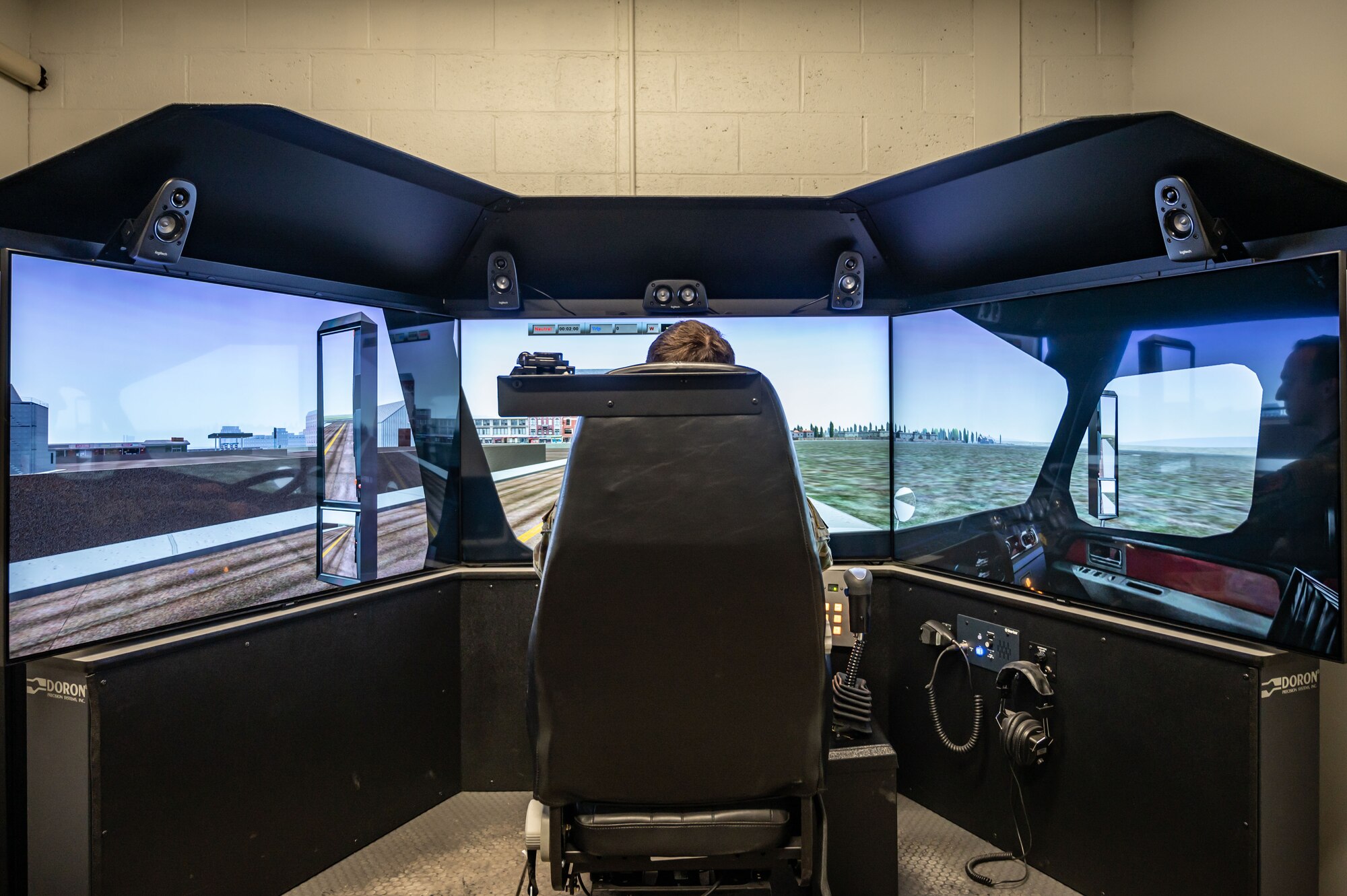 U.S Air Force Staff Sgt. Corey Beecher, assigned to the 103rd Logistics Readiness Squadron, is shown using a driving simulator, April 4, 2023 at Bradley Air National Guard Base, Connecticut. The driving simulator is used to practice driving skills through various scenarios and military vehicles. (U.S. Air National Guard photo by Airman Emme Drummond)