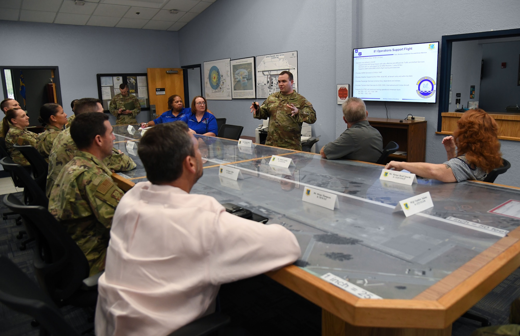U.S. Air Force Capt. Nicholas Juliano, 81st Operations Support Flight commander, briefs Col. Billy Pope, 81st Training Wing commander, on the 81st OSF's mission and capabilities during the Wing Staff Agencies Immersion Tour inside the base operations building at Keesler Air Force Base, Mississippi, April 11, 2023.
