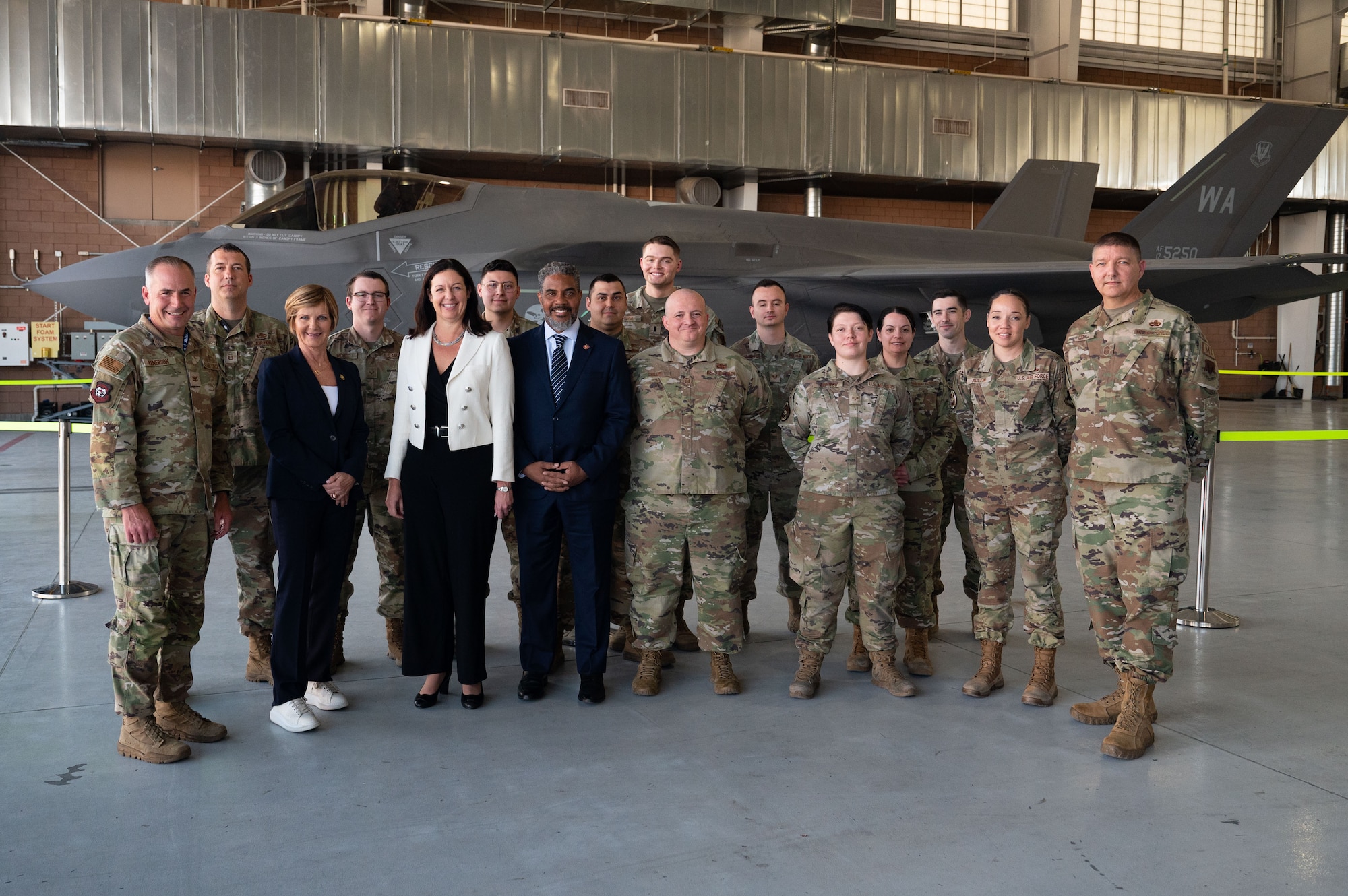 The Hon. Kristyn Jones, assistant secretary of the Air Force for Financial Management and Comptroller, performing the duties of under secretary of the Air Force, Congress members and Airmen pose for a group photo during a tour at Nellis Air Force Base, April 7, 2023.
