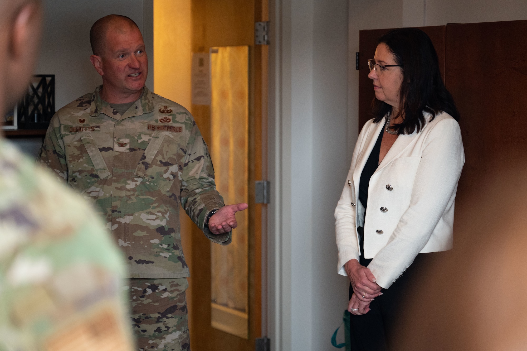 U.S. Air Force Col. Joshua DeMotts, 99th Air Base Wing commander, left, describes dorm conditions to the Hon. Kristyn Jones, assistant secretary of the Air Force for Financial Management and Comptroller, performing the duties of under secretary of the Air Force at Nellis Air Force Base, April 7, 2023.