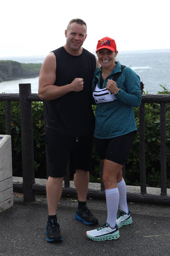 U.S. Marine Corps Maj. Larry Irsik, left, a manpower officer and deputy G-1 for 3d Marine Division, and Master Sgt. Crystal Thornock, career planner for 3d Marine Division, pose for a photo before their island-long trek at Cape Kyan, Okinawa, Japan, March 30, 2023. Irsik and Thornock ran from the southernmost to northernmost tips of the island of Okinawa, running 84 miles over a course of 23 hours. (U.S. Marine Corps photo by Lance Cpl. Evelyn Doherty)