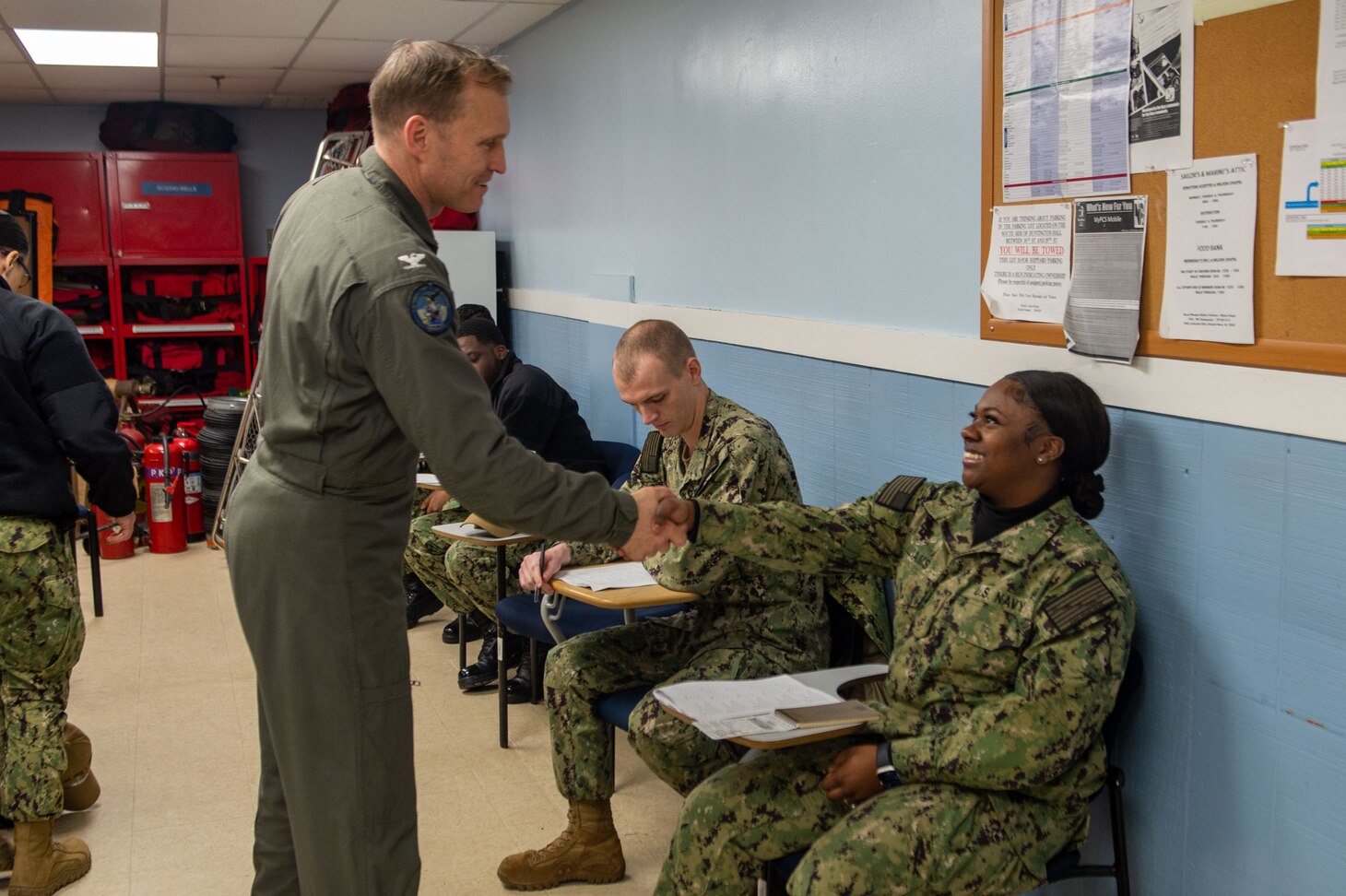 U.S. Navy Capt. Cassidy Norman, commanding officer of the Nimitz-class aircraft carrier USS John C. Stennis (CVN 74), interacts with Aviation Ordnanceman 3rd Class Jamari Denning, from Killeen, Texas, with new Sailors during a School of Ship a visit at Huntington Hall, Hampton Virginia, Feb. 14, 2023. The John C. Stennis is in Newport News Shipyard conducting Refueling and Complex Overhaul to prepare the ship for the second half of its 50-year service life.