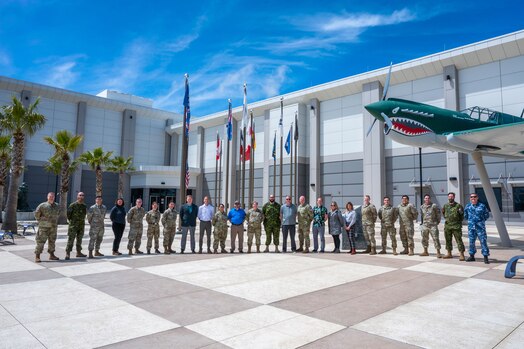  Participants and instructors of the Space Tacticians Course (STC), hosted by Space Delta 5’s 55th Combat Training Squadron, stand together in front of the Combined Force Space Component Command headquarters at Vandenberg Space Force Base, Calif., March 31, 2023. This iteration of STC was the first to include commercial representatives, indicating the progress being made to ensure consistent and timely information sharing between the military and commercial partners. The week-long course provides a wholistic approach to planning space operations by identifying current or potential barriers between participating parties, resulting in greater overall readiness for critical, real-world events. (U.S. Space Force photo by Tech. Sgt. Luke Kitterman)