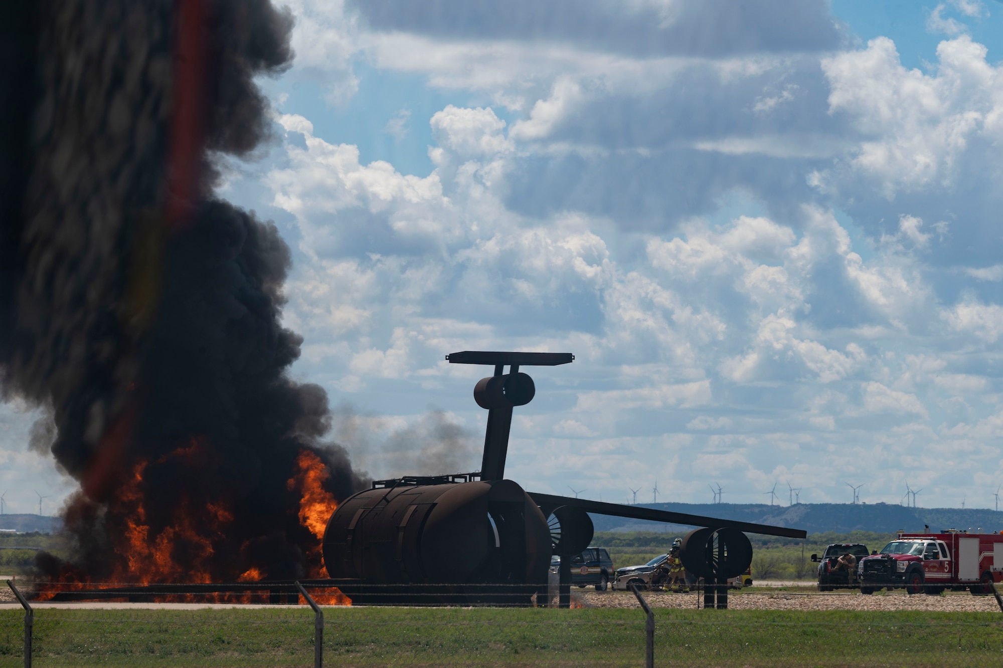 Firefighters from the 7th Civil Engineering Squadron conduct a live fire drill on Dyess Air Force Base, Texas, April 10, 2023. Firefighters from the 7th CES trained with Dallas Fort Worth and Abilene firefighters to educate them on effectively using Ultra High-Pressure systems to extinguish fires in minimal time. The training was held to not only educate civilian firefighters on Ultra High-Pressure systems but also to strengthen the partnership with local and state fire departments. (U.S. Air Force photo by Airman Emma Anderson)
