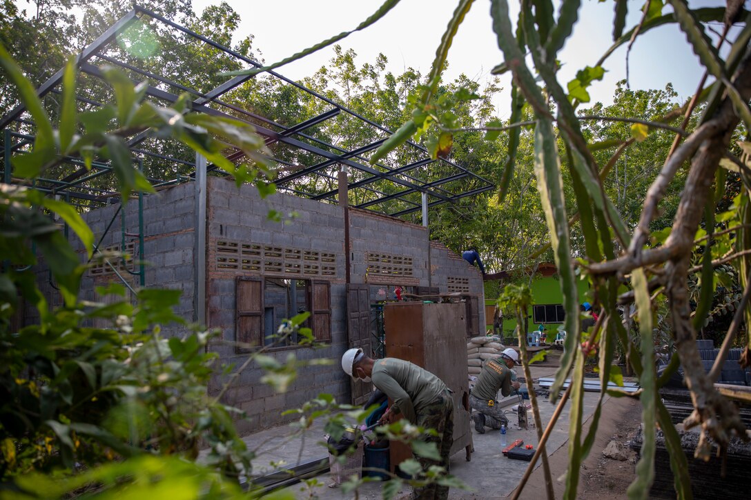 Service members from the Royal Thai Marine Corps, Republic of Korea Navy and Marine Corps, and the U.S. Marine Corps finish the reconstruction of a new roof for Miss Bunnam Inprom’s home during Exercise Cobra Gold 23 at Chanthaburi, Kingdom of Thailand, March 2, 2023. U.S. Marines and partner nations teamed up to build a new roof for Inprom’s home, which was destroyed by termites. Marine Wing Support Squadron 171 and MWSS-172 participated in the 42nd iteration of the Cobra Gold series of exercises, where they lended their engineering expertise to multilateral humanitarian efforts.