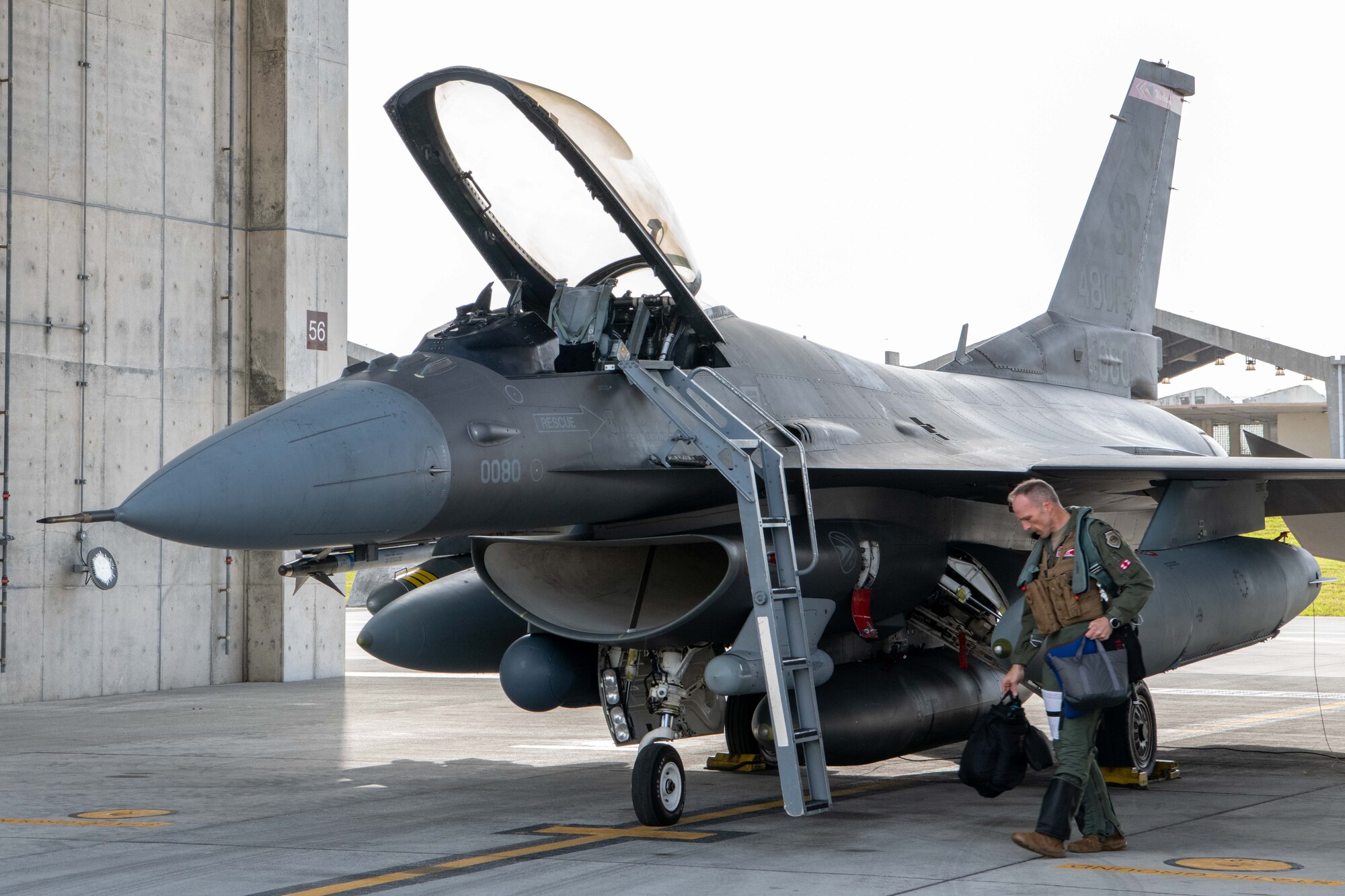 An Airman carries a flight bag.