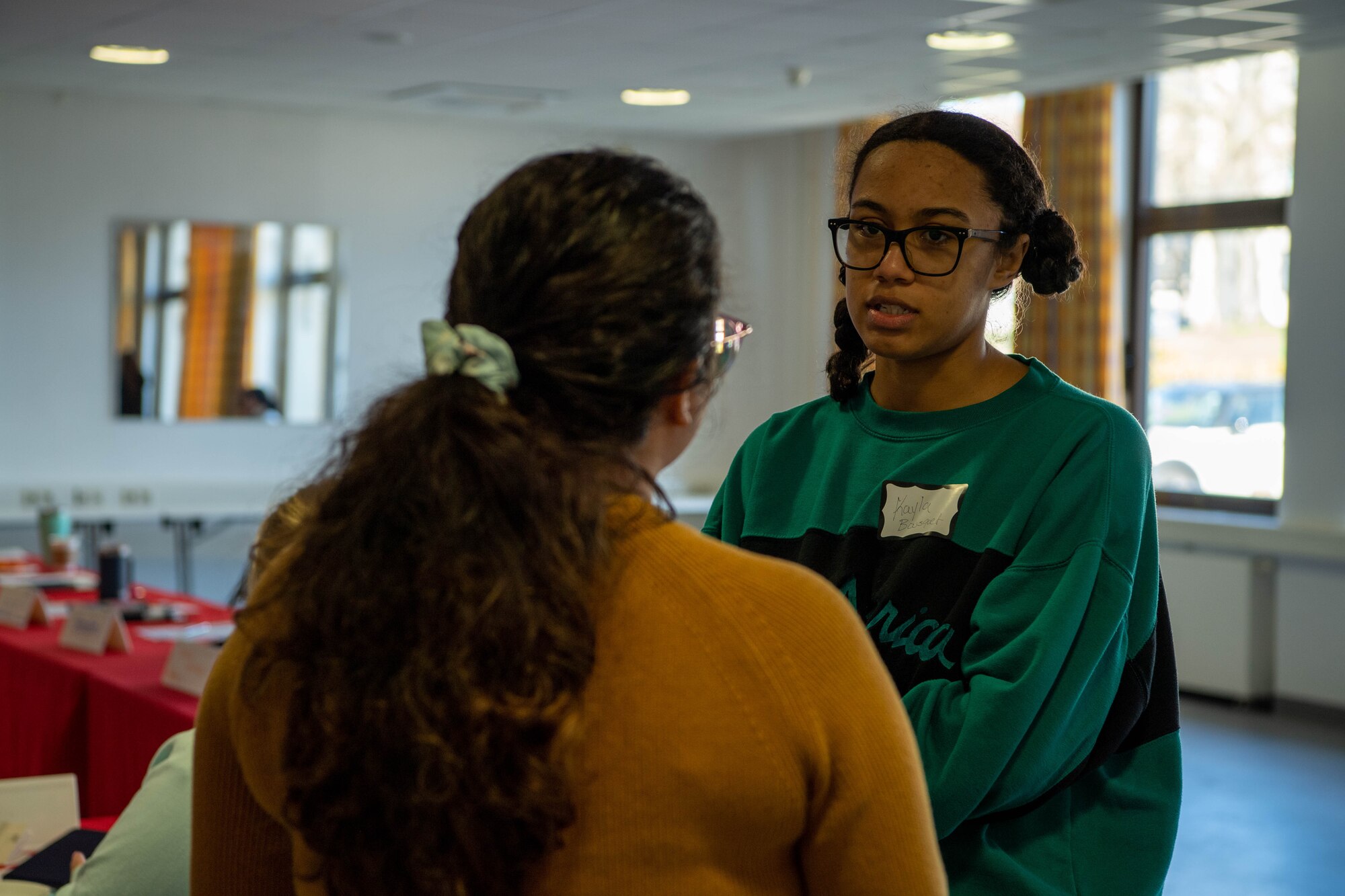 Kayla Bousquet, a 691st Cyberspace Operation Squadron military spouse, speaks with a helping agency representative at a Military & Family Readiness Center’s Heart Link spouse orientation program at Ramstein Air Base, Germany, April 4, 2023.