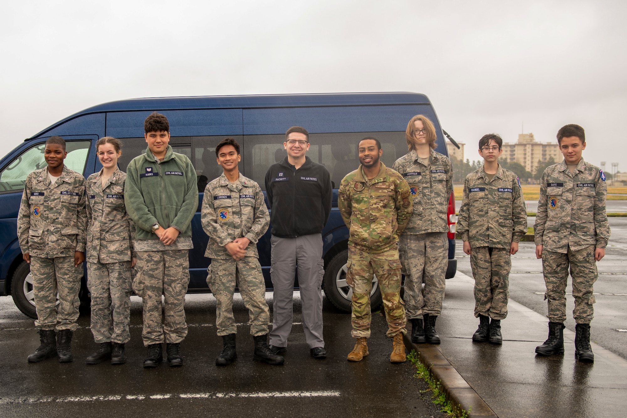 kids in military uniforms line up in front of a van