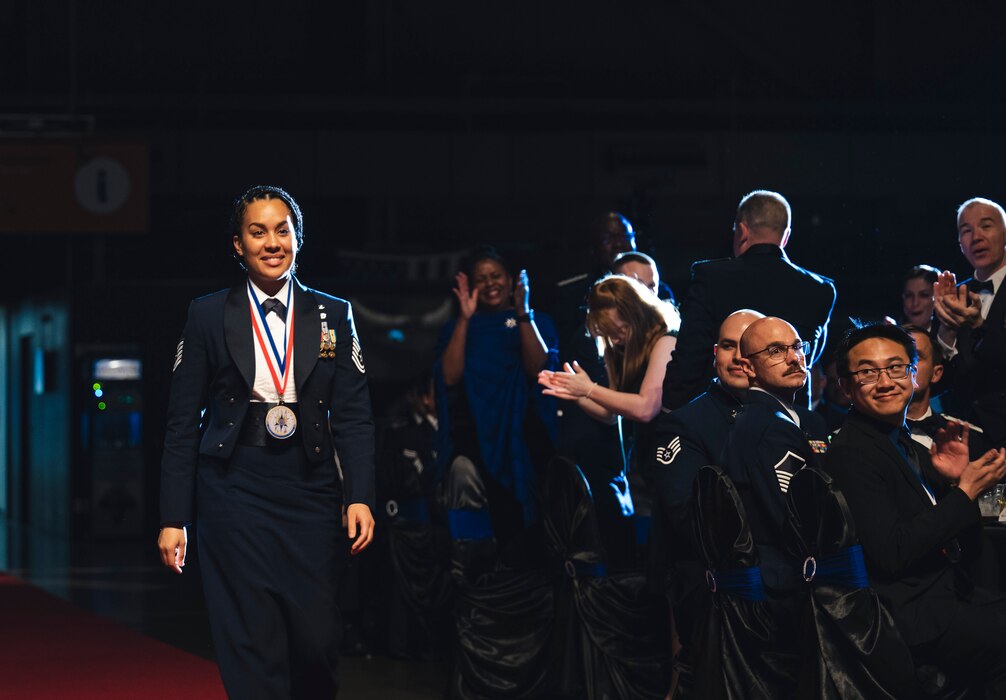 Staff Sgt. Michaela Mahan, Air Force Sustainment Center, is cheered while walking up to receive her Air Force Materiel Command Annual Excellence Award April 5 during the AFMC AEA Banquet in the National Museum of the U.S. Air Force at Wright-Patterson Air Force Base, Ohio.