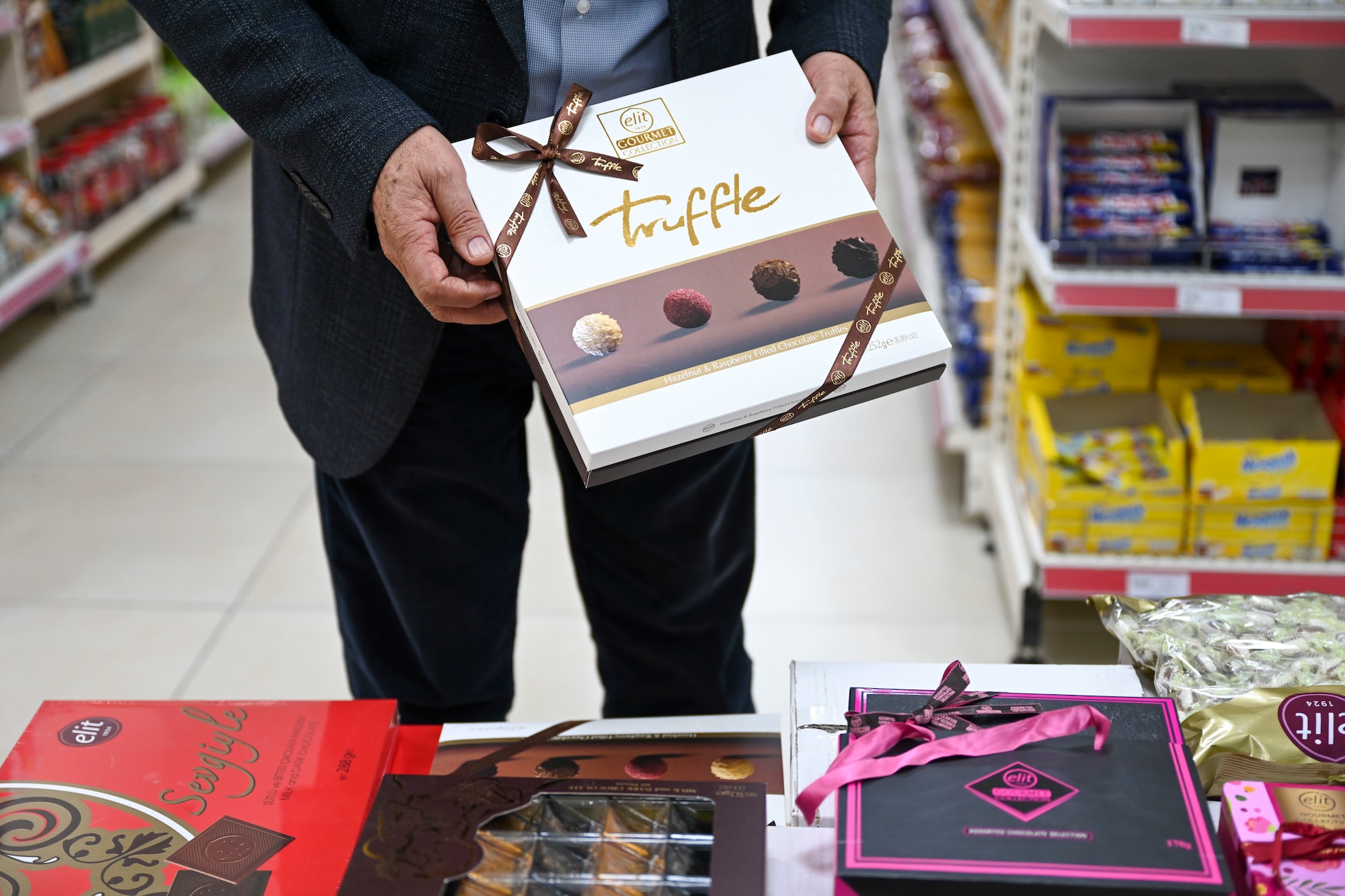 Mehmet Birbiri, 39th Air Base Wing Public Affairs host nation advisor, showcases gifts that are commonly given during the 3 ½-day Sugar Festival at Incirlik Air Base, Türkiye, April 13, 2023.