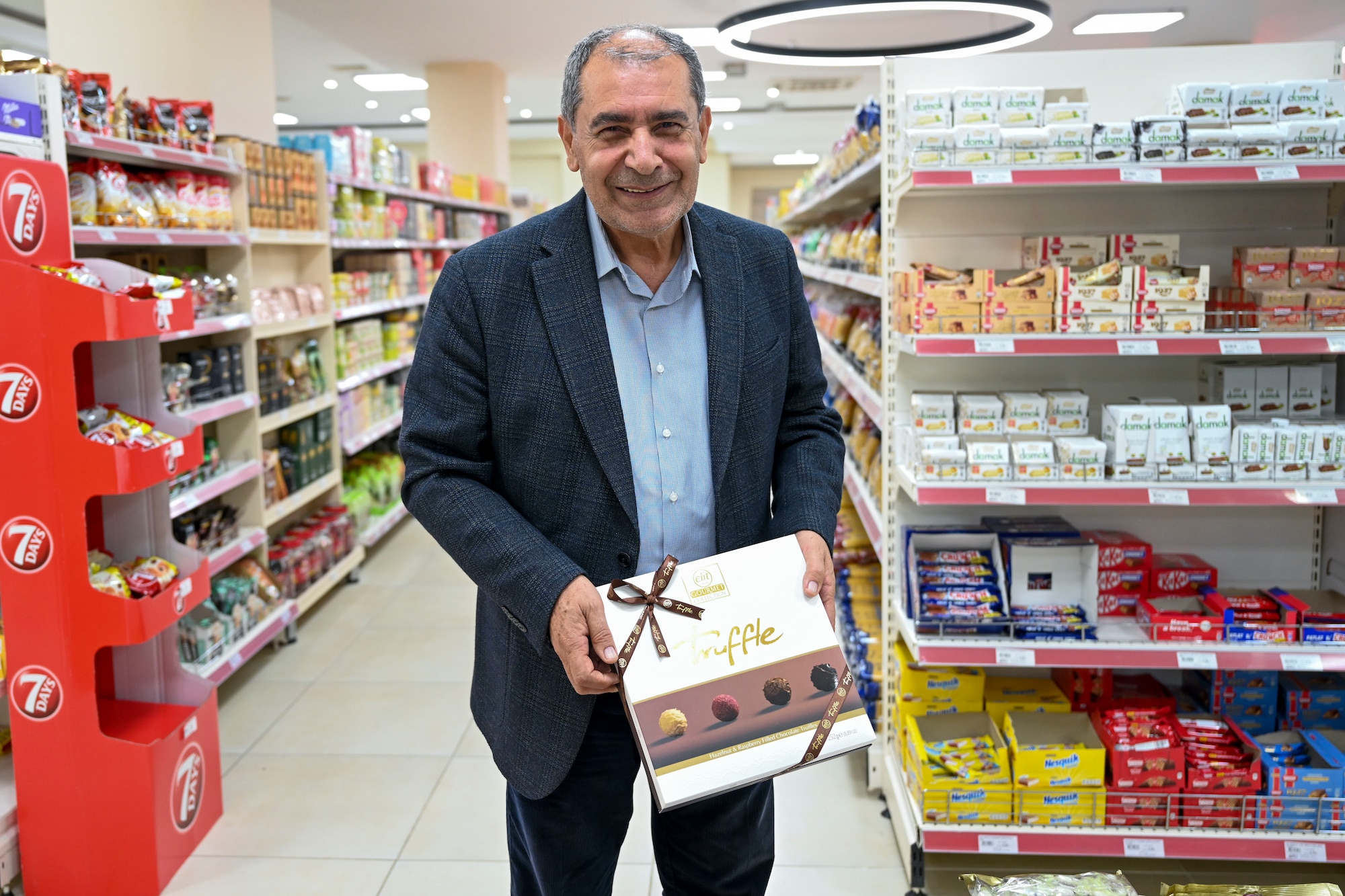 Mehmet Birbiri, 39th Air Base Wing Public Affairs host nation advisor, showcases gifts that are commonly given during the 3 ½-day Sugar Festival at Incirlik Air Base, Türkiye, April 13, 2023.