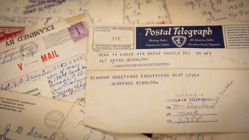 The last telegram sent by Kentucky Army National Guard Sgt. Jennings Bryan Scanlon from Manila, Philippines Island, dated Dec. 28, 1941. This telegrama and the return to sender letters in the background were donated to the Kentucky National Guard by an anonymous veteran who found them at an estate auction in Harrodsburg, Ky. The letters in the background are from his family and returned to sender after Scanlon was captured by Japanese forces. (U.S. Army photo by Andy Dickson)