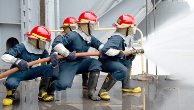 Sailors simulate extinguishing a fire during damage control training aboard USS Theodore Roosevelt (CVN 71) at Naval Base San Diego.