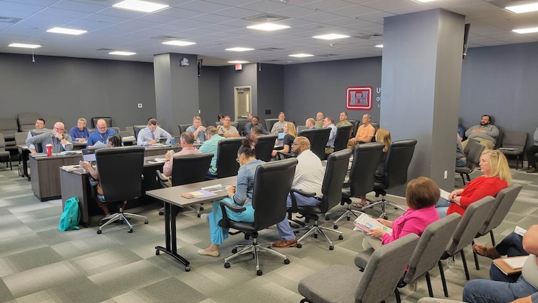 Several people sitting around a conference table.
