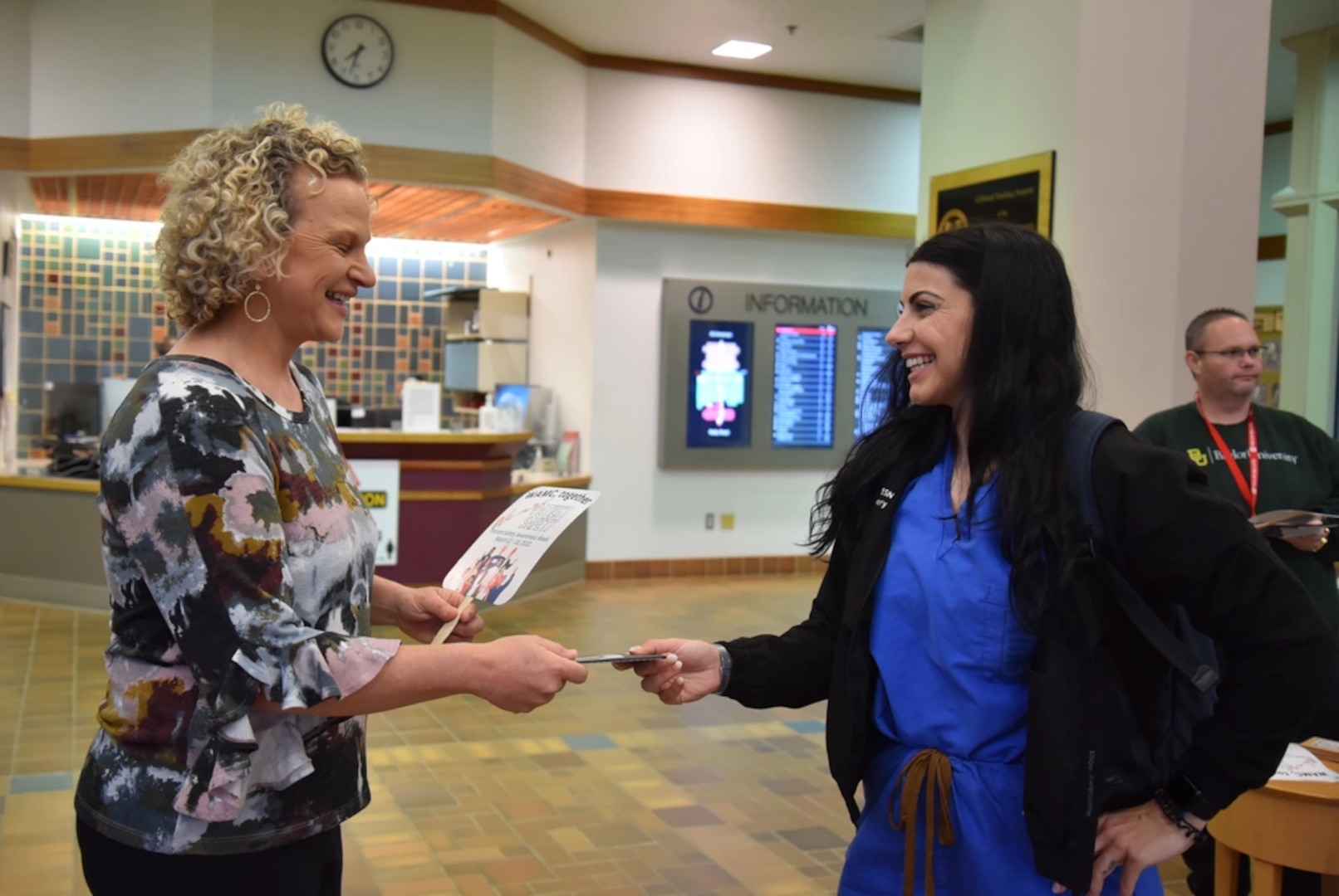 Patient Safety ambassador, Kriestin Kleinschmidt, inpatient case management and utilization management supervisor distributes various patient safety items at the Reilly Road entrance of Womack Army Medical Center (WAMC).