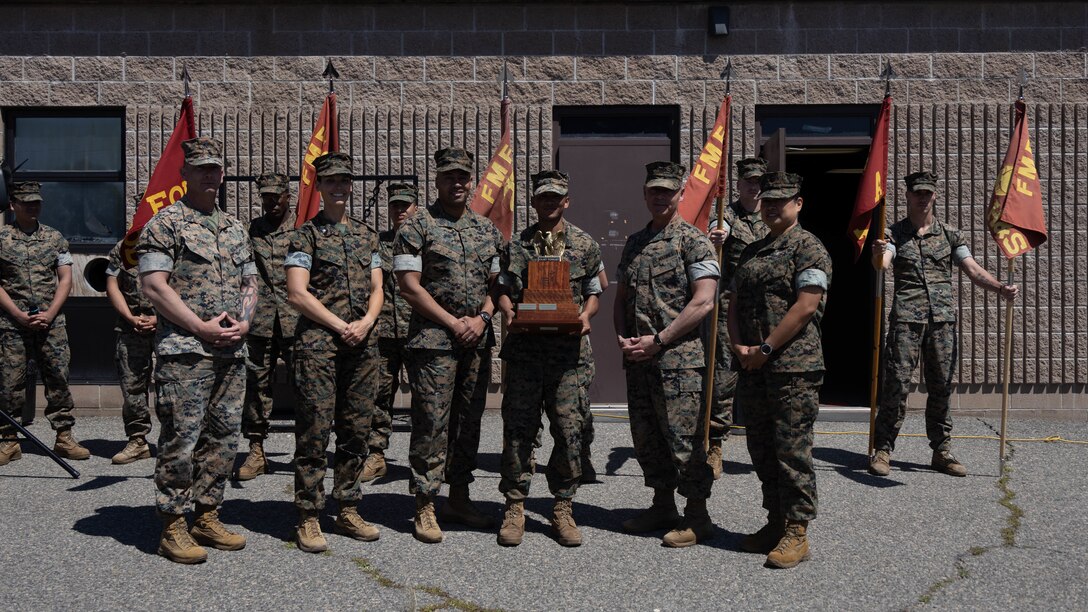 U.S. Marines with 7th Engineer Support Battalion and 1st Marine Logistics Group, I Marine Expeditionary Force pose for a group photo during an awards ceremony on Camp Pendleton, California, Mar. 5, 2023. The commanding general selected 7th Engineer Support Battalion based on a wholistic concept of readiness which includes the easily measurable aspects of individual, equipment, and training readiness, but it also includes the less measurable aspects that multiply a unit's combat effectiveness like cohesion, esprit de corps, trust up and down the chain of command, and individual discipline and integrity. The 1st MLG “Fight Tonight” award is part of the 1st MLG’s commitment to provide a logistical force capable of fighting on a moment’s notice. (U.S. Marine Corps photo by Lance Cpl. Bradley Ahrens)