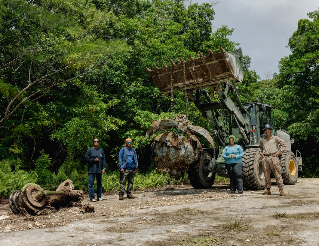 U.S. Marine Corps Cpl. Erik Willis, right, an engineer equipment operator from 7th Engineer Support Battalion assigned to Marine Corps Engineer Detachment – Palau, an archeologist, and Peleliu State Office officials pose for a group photo with WWII artifacts excavated on Peleliu, Republic of Palau, March 3, 2023. Marines with MCED-Palau worked with local officials to prepare future project sites and preserve historical artifacts. During this rotational deployment of MCED-Palau, Navy Seabees and Marine Corps engineers undertake infrastructure projects which benefit local populations in the Indo-Pacific and enhance the United States’ ability to render support and aid in response to disasters or other crises. (U.S. Marine Corps photo by Cpl. Casandra Lamas)