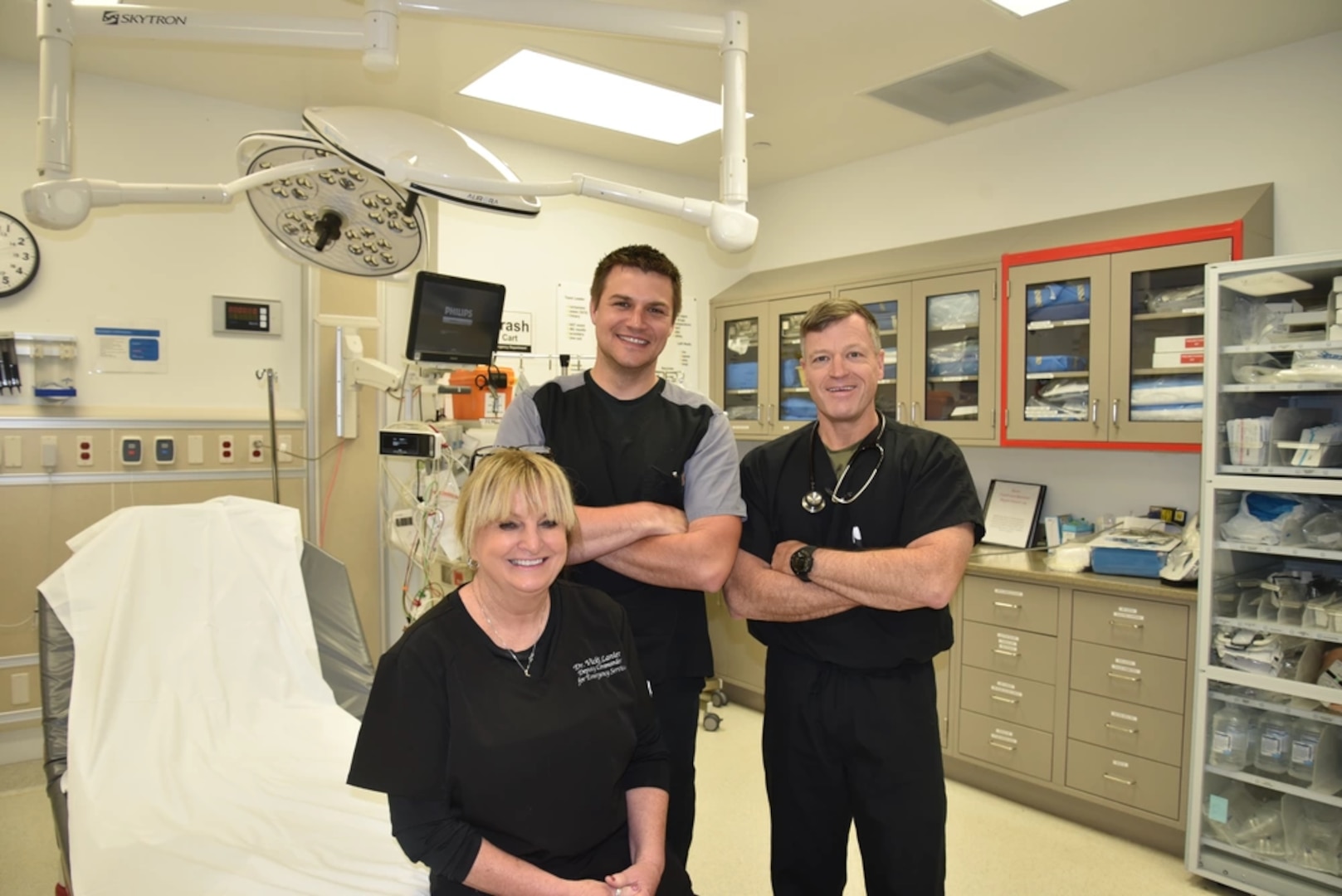 Dr. Vicki Lanier, Womack Army Medical Center deputy commander of Emergency Services and Department of Emergency Medicine chief, pose for a photo with attending physicians Christopher House and Peter Benson in WAMC trauma room, March 29, 2023.