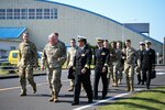 Leaders of United States Forces Japan, the 374th Airlift Wing, and the 319th Expeditionary Reconnaissance Squadron walk to the Kanoya Air Base headquarters building during a visit to Kanoya Air Base, Japan, April 10, 2023. USFJ and 374th AW command teams also met with Shigeru Nakanishi, Kanoya mayor, and recognized Airmen from the 319th ERS for their commitment to contributing positively to the Kanoya community.