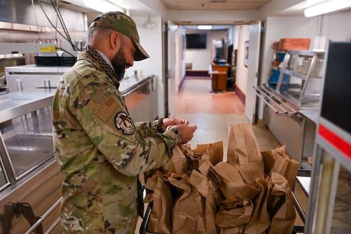 Airman 1st Class Riyadh Al-Shihmani, a 934th Force Support Squadron services specialist, packs lunches at the Community Activity Center in Minneapolis-St. Paul Air Reserve Station, Minnesota, April 1, 2023. Al-Shihmani was originally from Iraq, and it was his dream to come to America and join the U.S. military. (U.S. Air Force photo by Senior Airman Matthew Reisdorf)