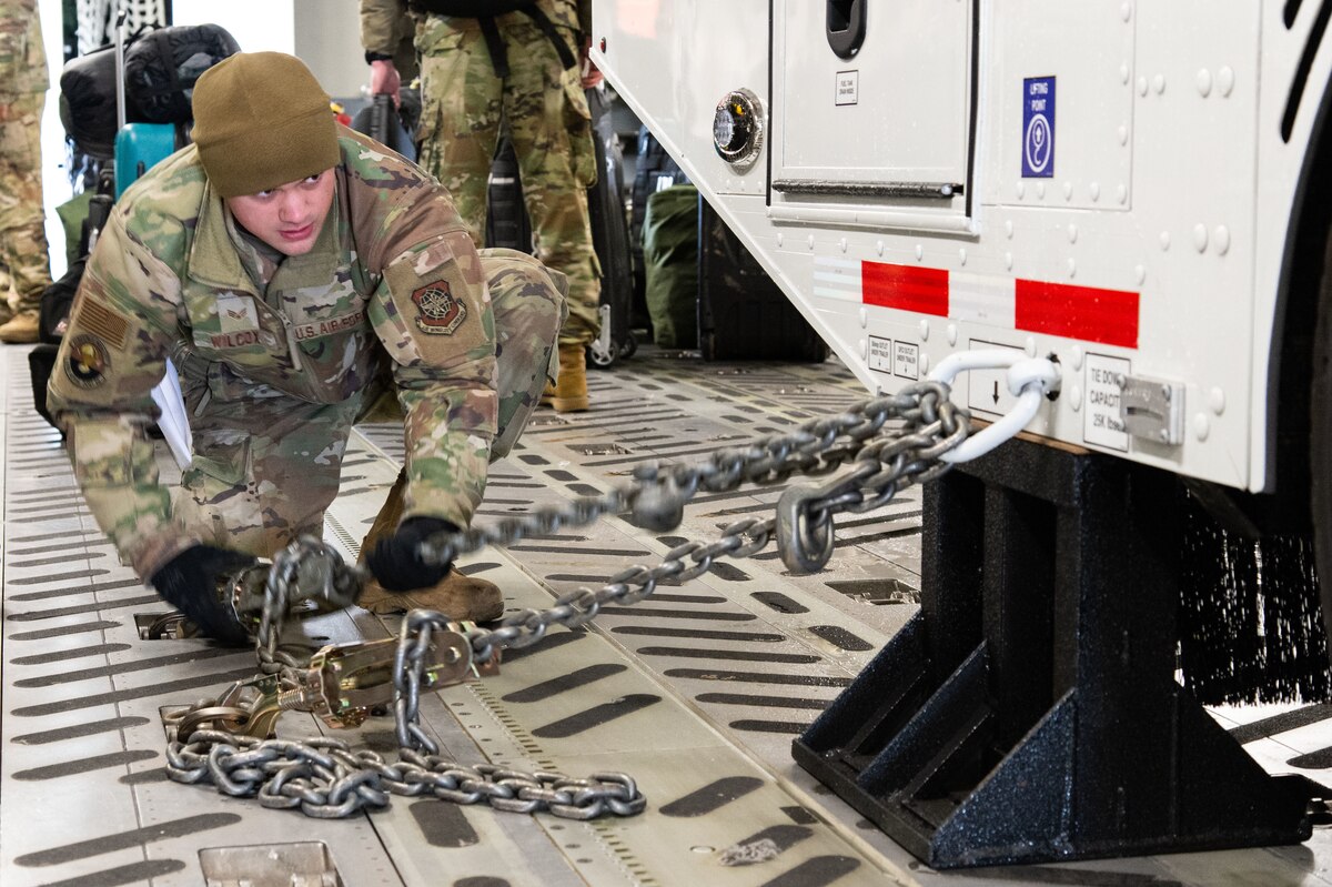 Senior Airman Jacob Wilcox, 436th Aerial Port Squadron ramp service specialist, secures a Mobile Remote Quick Look trailer to the cargo floor of a C-17 Globemaster III at Dover Air Force Base, Delaware, Feb. 1, 2023. The RQL trailer will be used to support the U.S. Navy MQ-4C Triton Orbit 1 operations at Andersen AFB, Guam. The MQ-4C is an unmanned aerial vehicle operated by the U.S. Navy for maritime patrol supporting intelligence, surveillance and reconnaissance operations. (U.S. Air Force photo by Roland Balik)