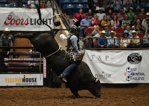 A bull rider competes at the San Angelo Rodeo for Military Appreciation Night, San Angelo, Texas, April 12, 2023. Bull riding is a rodeo sport that involves a rider getting on a bucking bull and attempting to stay mounted while the animal tries to dislodge the rider. (U.S. Air Force photo by Airman 1st Class Zach Heimbuch)