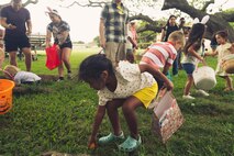 A child retrieves an egg during the Headquarters Battalion Spring Egg-stravaganza, Marine Corps Base Hawaii, April 7, 2023. The event was held to provide Marines, Sailors, and their families with an opportunity to participate in spring activities. (U.S. Marine Corps photo by Cpl. Brandon Aultman)