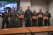 U.S. Navy Cmdr. Kevin Meinert, Executive Officer of Marine Aviation Logistics Squadron 24, Marines with Marine Aircraft Group 24, poses for a photo with Marines assigned to MAG-24 during a Marine Corps Aviation Awards ceremony, Marine Corps Base Hawaii, April 4, 2023. The service members received awards for outstanding performance in Marine Aviation. (U.S. Marine Corps photo by Lance Cpl. Clayton Baker)