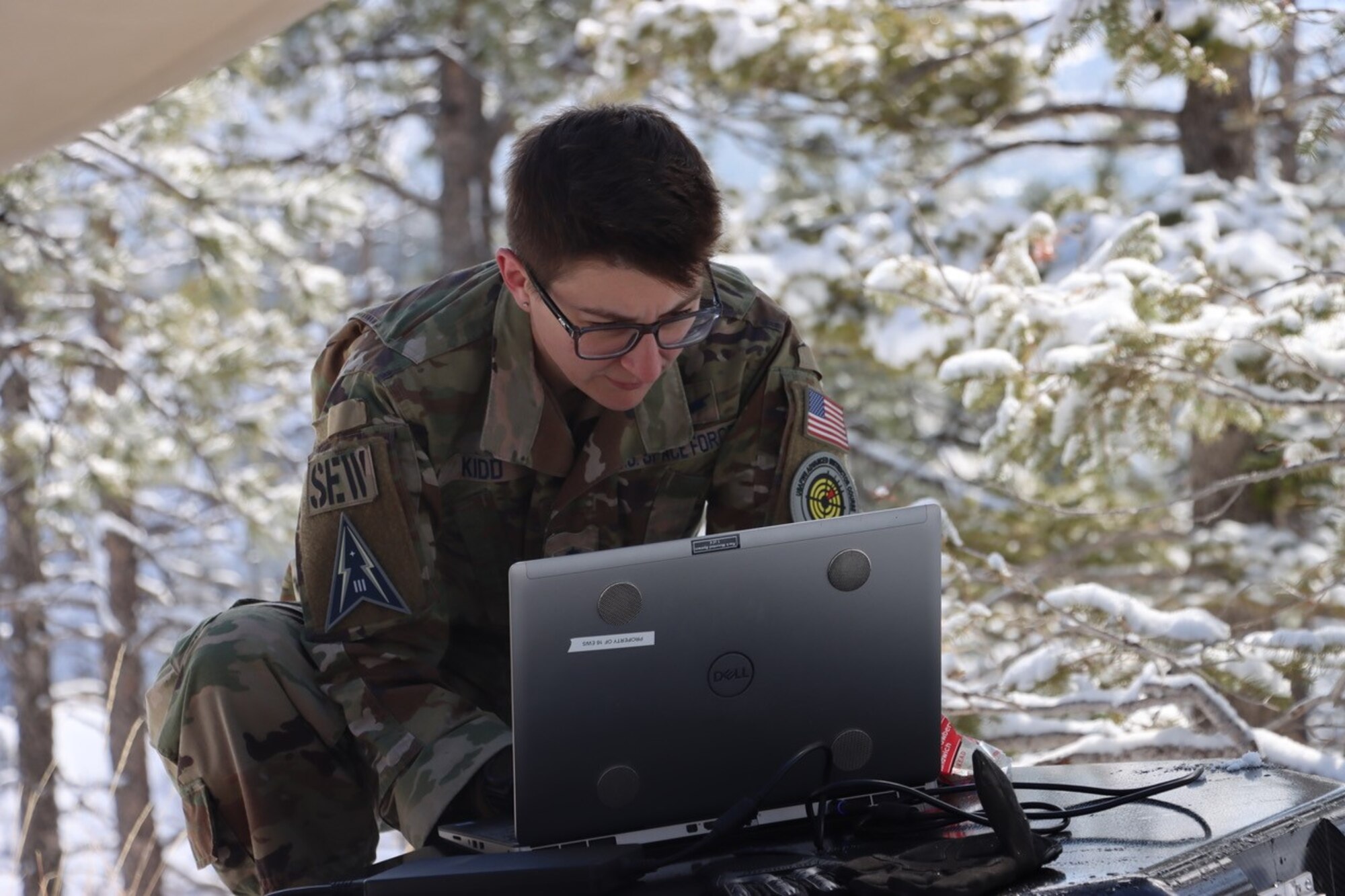 PETERSON SPACE FORCE BASE, Colorado - A Member of Space Delta 3's Quick Reaction Force assists in setting up the Electromagnetic Warfare system. The QRF completed the Crucible event—a 4-mile, 1,292 ft. elevation gain hike—on April 6 where the team transported a 500+ pound Electromagnetic Warfare system and set up operations mountain-side, proving the agility and mobility of both the developmental system and the team. (Courtesy Photo)