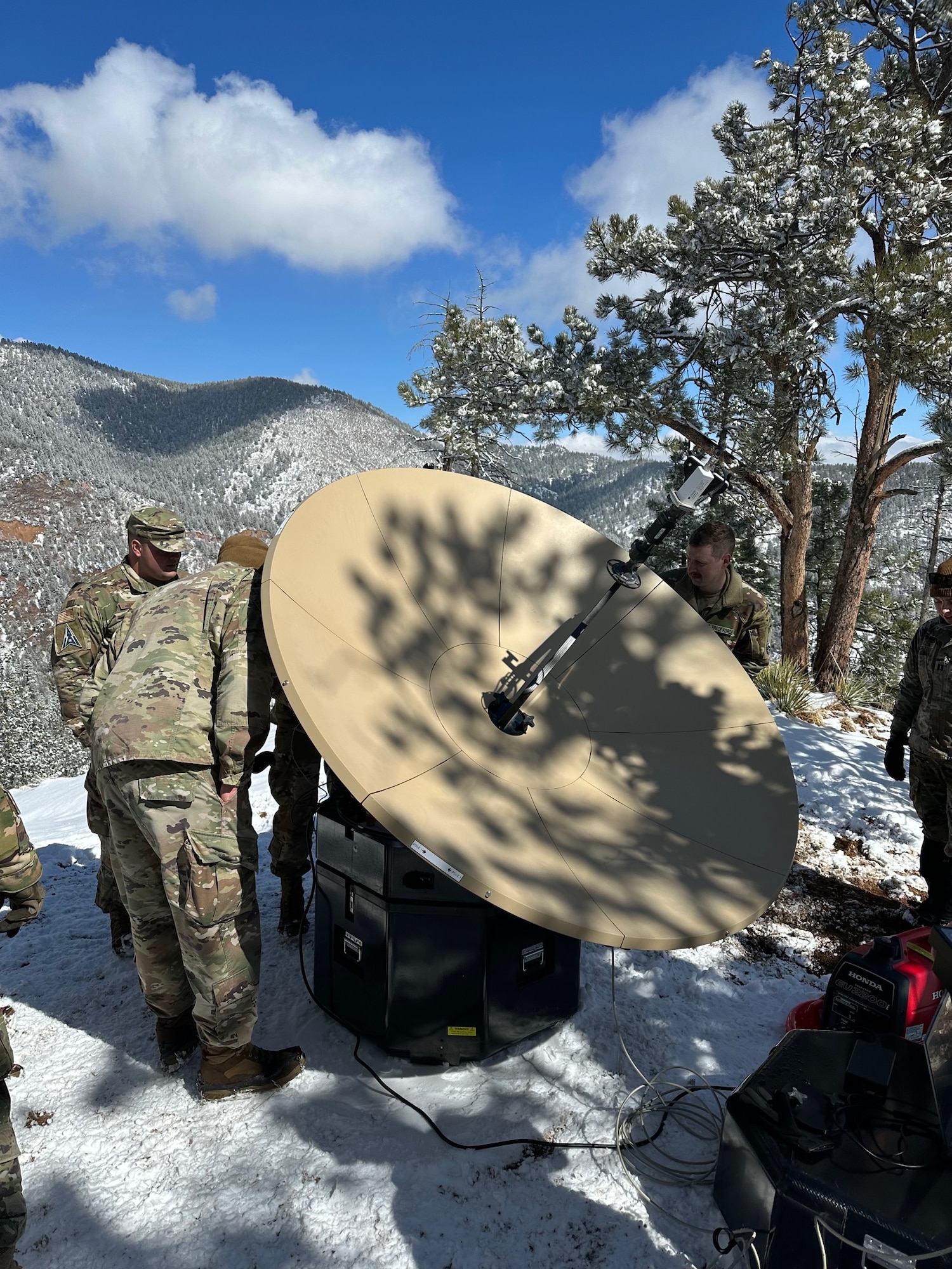PETERSON SPACE FORCE BASE, Colorado - Members of Space Delta 3's Quick Reaction Force assist in setting up the Electromagnetic Warfare system. The QRF completed the Crucible event—a 4-mile, 1,292 ft. elevation gain hike—on April 6 where the team transported a 500+ pound Electromagnetic Warfare system and set up operations mountain-side, proving the agility and mobility of both the developmental system and the team. (Courtesy Photo)