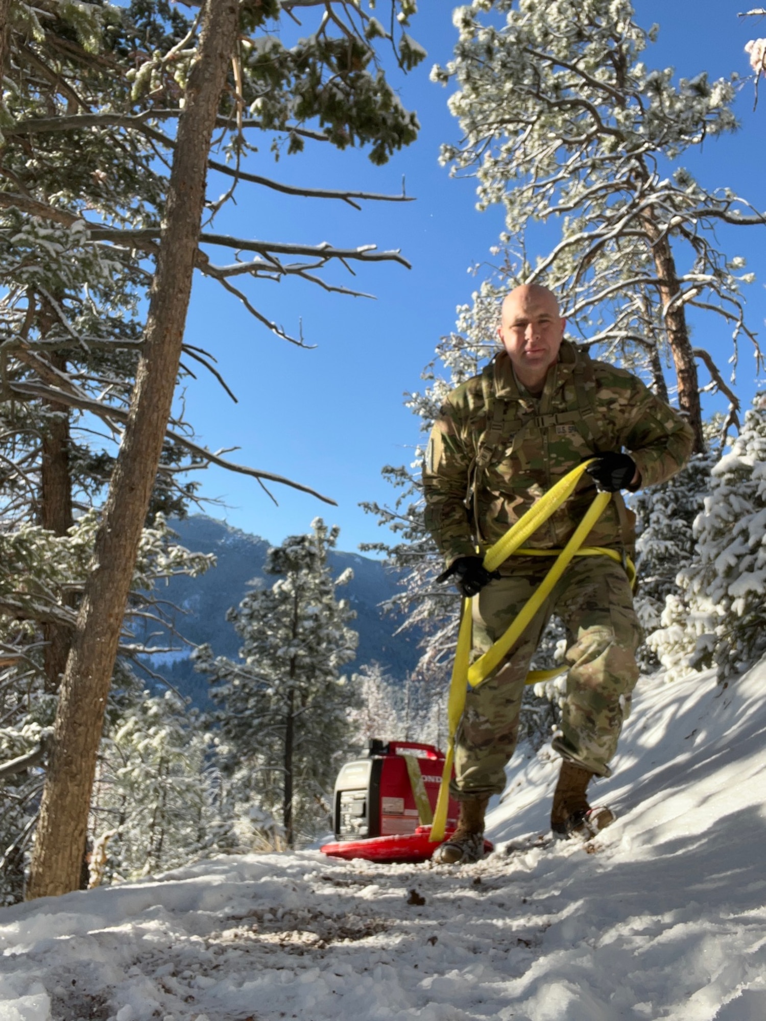 PETERSON SPACE FORCE BASE, Colorado - Col. Christopher Fernengel and members from Space Delta 3's Quick Reaction Force transport equipment up Mt. Muscoco. The QRF completed the Crucible event—a 4-mile, 1,292 ft. elevation gain hike—on April 6 where the team transported a 500+ pound Electromagnetic Warfare system and set up operations mountain-side, proving the agility and mobility of both the developmental system and the team. (Courtesy Photo)